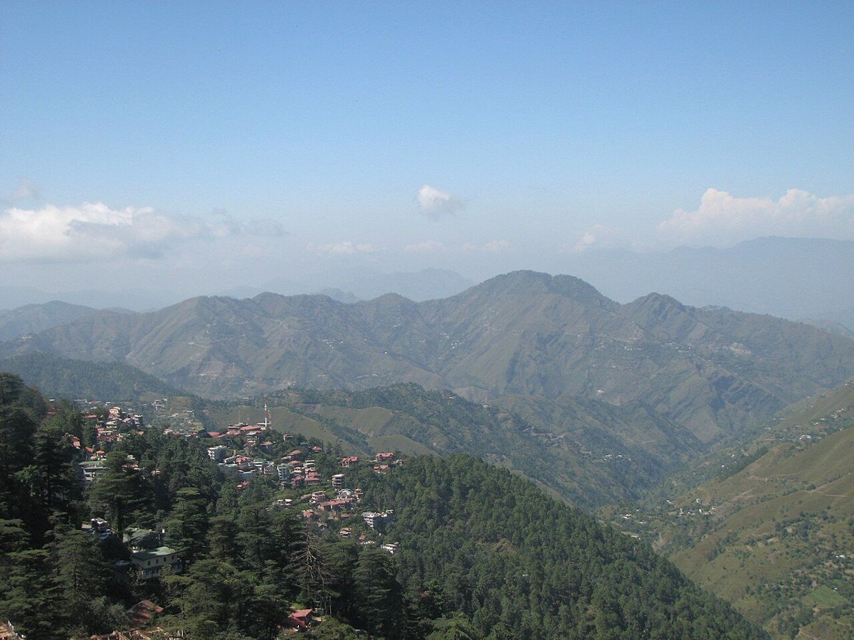 Forested hills and scattered buildings seen from Shimla, Himachal Pradesh.